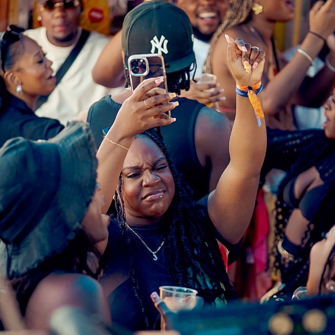 Crowd dancing and taking photos at a party
